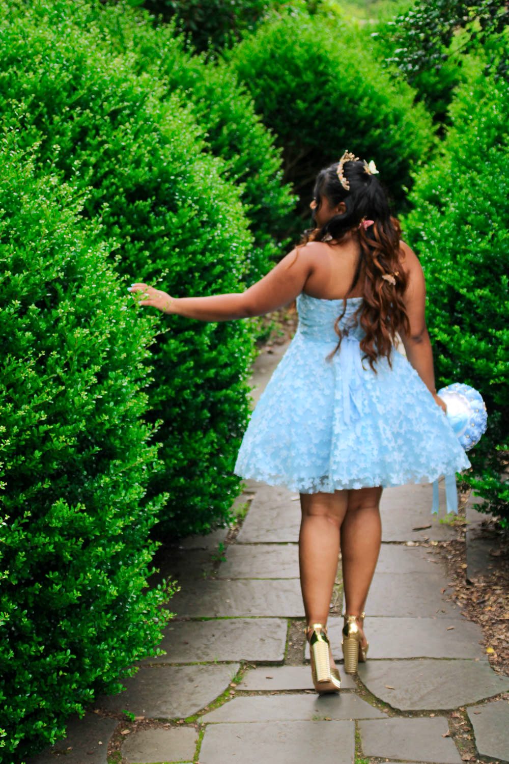 Pre-sweet 16 photoshoot in a garden, blue dress
